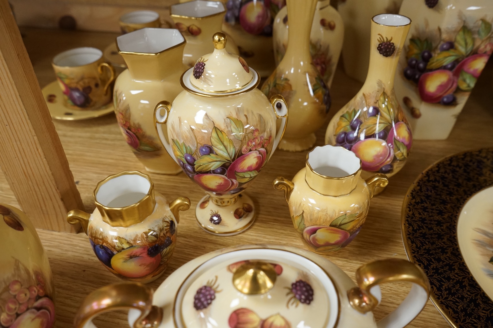 A collection of Aynsley ‘Orchard Gold’ fruit-painted tea/dinner wares and vases, largely signed by D Jones, largest 26cm in diameter